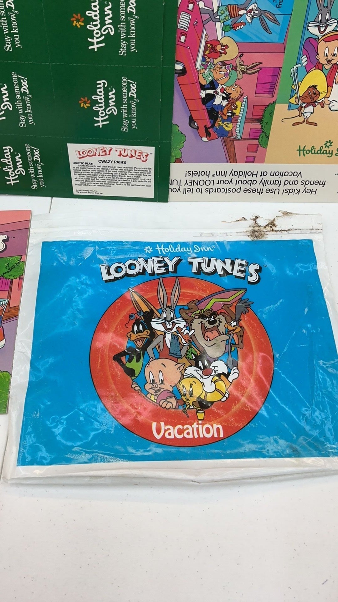 12B- 1990 Holiday Inn Looney Tunes vacation packet with card game, activity booklet, etc.