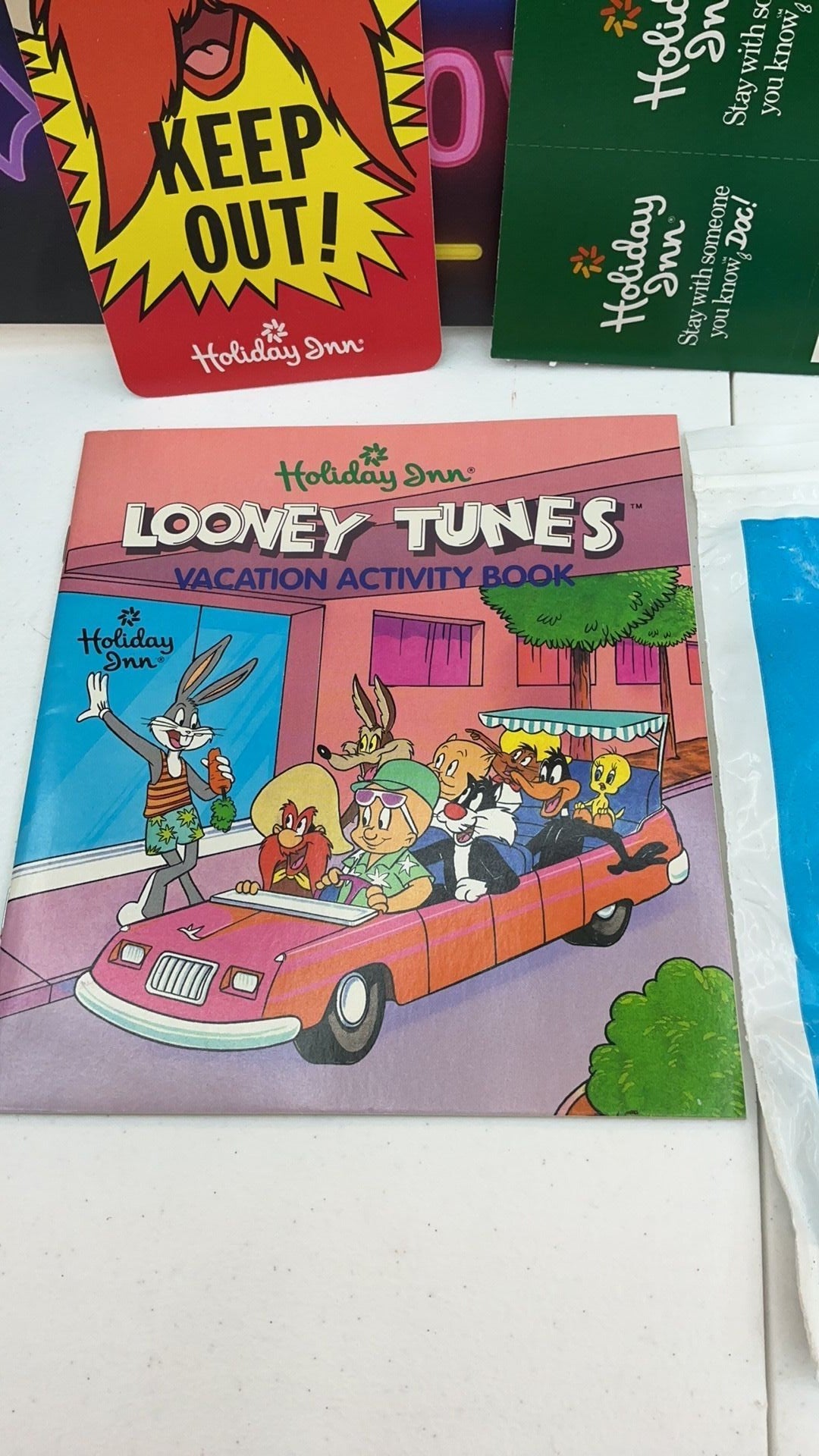 12B- 1990 Holiday Inn Looney Tunes vacation packet with card game, activity booklet, etc.