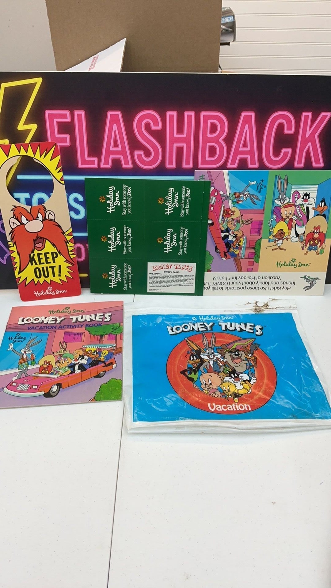 12B- 1990 Holiday Inn Looney Tunes vacation packet with card game, activity booklet, etc.